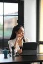 Portrait of businesswoman sitting in office while looking through window think about future hope for new opportunities. Royalty Free Stock Photo