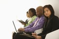 Portrait of businesswoman sitting with others.