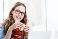 Portrait of businesswoman smiling while eating sandwich in her desk Royalty Free Stock Photo