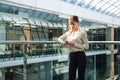 Portrait of a businesswoman are standing on the background of glass offices.