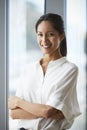 Portrait Of Businesswoman Standing By Window In Office Royalty Free Stock Photo