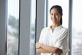 Portrait Of Businesswoman Standing By Window In Office Royalty Free Stock Photo