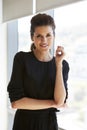 Portrait Of Businesswoman Standing By Window In Office Royalty Free Stock Photo