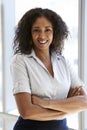 Portrait Of Businesswoman Standing By Window In Office Royalty Free Stock Photo