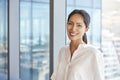 Portrait Of Businesswoman Standing By Window In Office Royalty Free Stock Photo