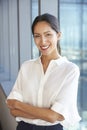 Portrait Of Businesswoman Standing By Window In Office Royalty Free Stock Photo