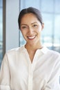 Portrait Of Businesswoman Standing By Window In Office Royalty Free Stock Photo