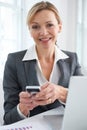 Portrait Of Businesswoman Texting On Mobile Phone