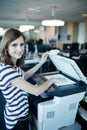 Portrait of businesswoman using copy machine in office Royalty Free Stock Photo