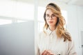 Portrait of businesswoman wearing glasses at workplace at coworking space Royalty Free Stock Photo