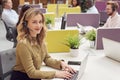 Portrait Of Businesswoman Wearing Phone Headset Talking To Caller In Busy Customer Services Centre Royalty Free Stock Photo