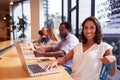 Portrait Of Businesswoman Working At Desk In Shared Open Plan Office Workspace Royalty Free Stock Photo