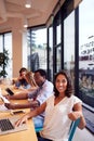 Portrait Of Businesswoman Working At Desk In Shared Open Plan Office Workspace Royalty Free Stock Photo