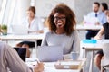 Portrait Of Businesswoman Working On Laptop In Busy Office Royalty Free Stock Photo