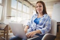 Portrait of businesswoman working on laptop in office Royalty Free Stock Photo
