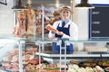 Portrait Of Butcher Standing Behind Counter Royalty Free Stock Photo