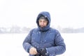 Portrait of 40c man in winter clothes in heavy snow.