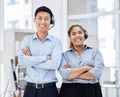 Portrait of call center colleagues. Businesspeople working in customer service wearing headsets, arms crossed.Smiling Royalty Free Stock Photo