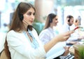 Portrait of call center worker accompanied by her team. Smiling customer support operator at work. Royalty Free Stock Photo