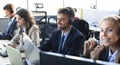 Portrait of call center worker accompanied by his team. Smiling customer support operator at work Royalty Free Stock Photo