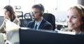 Portrait of call center worker accompanied by his team. Smiling customer support operator at work Royalty Free Stock Photo