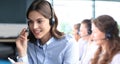 Portrait of call center worker accompanied by his team. Smiling customer support operator at work Royalty Free Stock Photo