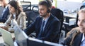 Portrait of call center worker accompanied by his team. Smiling customer support operator at work Royalty Free Stock Photo