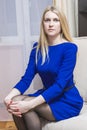 Portrait of Calm Blond Woman Sitting in Light Chair.