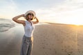 Portrait of calm, relaxed girl, carefree traveler woman enjoying summer vacation, walking on the sandy beach