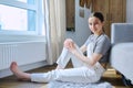 Portrait of calm smiling teenage girl sitting on floor at home Royalty Free Stock Photo