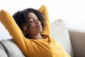 Portrait Of Calm Young Black Woman Resting On Comfortable Sofa At Home Royalty Free Stock Photo