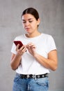 Calm young woman looking interestedly at mobile Royalty Free Stock Photo