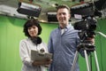 Portrait Of Cameraman And Floor Manager In Television Studio