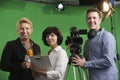 Portrait Of Cameraman With Presenter And Floor Manager In Televi