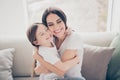 Portrait of candid cute sweet two people lovely mom and her kid girl hug mother cuddle enjoy spend free time together