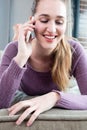 Portrait of candid happy gorgeous teenage girl talking on phone