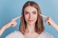 Portrait of candid healthy girl direct forefingers eyes look camera on blue background