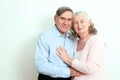 Portrait of candid senior couple enjoying their retirement. Affectionate elderly couple with beautiful beaming friendly smiles pos Royalty Free Stock Photo