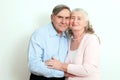 Portrait of candid senior couple enjoying their retirement. Affectionate elderly couple with beautiful beaming friendly smiles pos Royalty Free Stock Photo