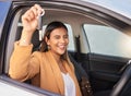 Portrait, car and woman with a key, smile and celebration with achievement, goals and success. Face, wink and happy girl