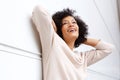 Carefree african american woman smiling with hands behind head Royalty Free Stock Photo