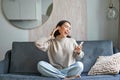 Portrait of carefree asian woman singing and listening music from smartphone app, using wireless headphones, smiling Royalty Free Stock Photo