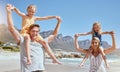 Portrait of carefree family having fun and relaxing on beach. Cheerful little girls playing with their mother and father Royalty Free Stock Photo