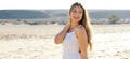 Portrait of carefree girl walking on sand beach looking back. Pretty young smiling woman on spring time at beach panoramic banner Royalty Free Stock Photo