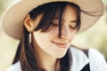 Portrait of carefree hipster girl with backpack traveling on top of sunny mountain. Stylish woman in hat and windy hair enjoying Royalty Free Stock Photo