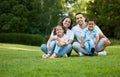 Portrait of carefree mixed race family spending time together at park. Happy parents with son and daughter bonding and Royalty Free Stock Photo