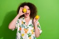 Portrait of carefree overjoyed person hold lemon cover one eye empty space isolated on green color background