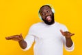 Portrait of carefree positive guy enjoy excited melody sound have fun isolated on yellow color background