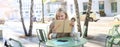 Portrait of carefree, smiling young woman with notebook and pen, sitting in outdoor cafe near table, writing in journal Royalty Free Stock Photo