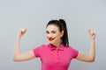 Portrait of a carefree young woman smiling with arms raised, sport Royalty Free Stock Photo